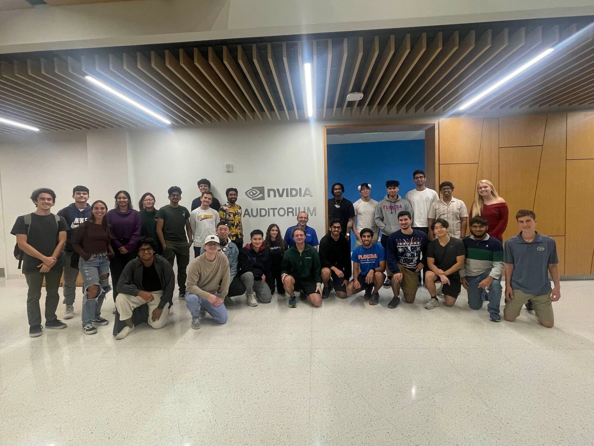 About thirty workshop attendees posing in front of the NVIDIA Auditorium sign
